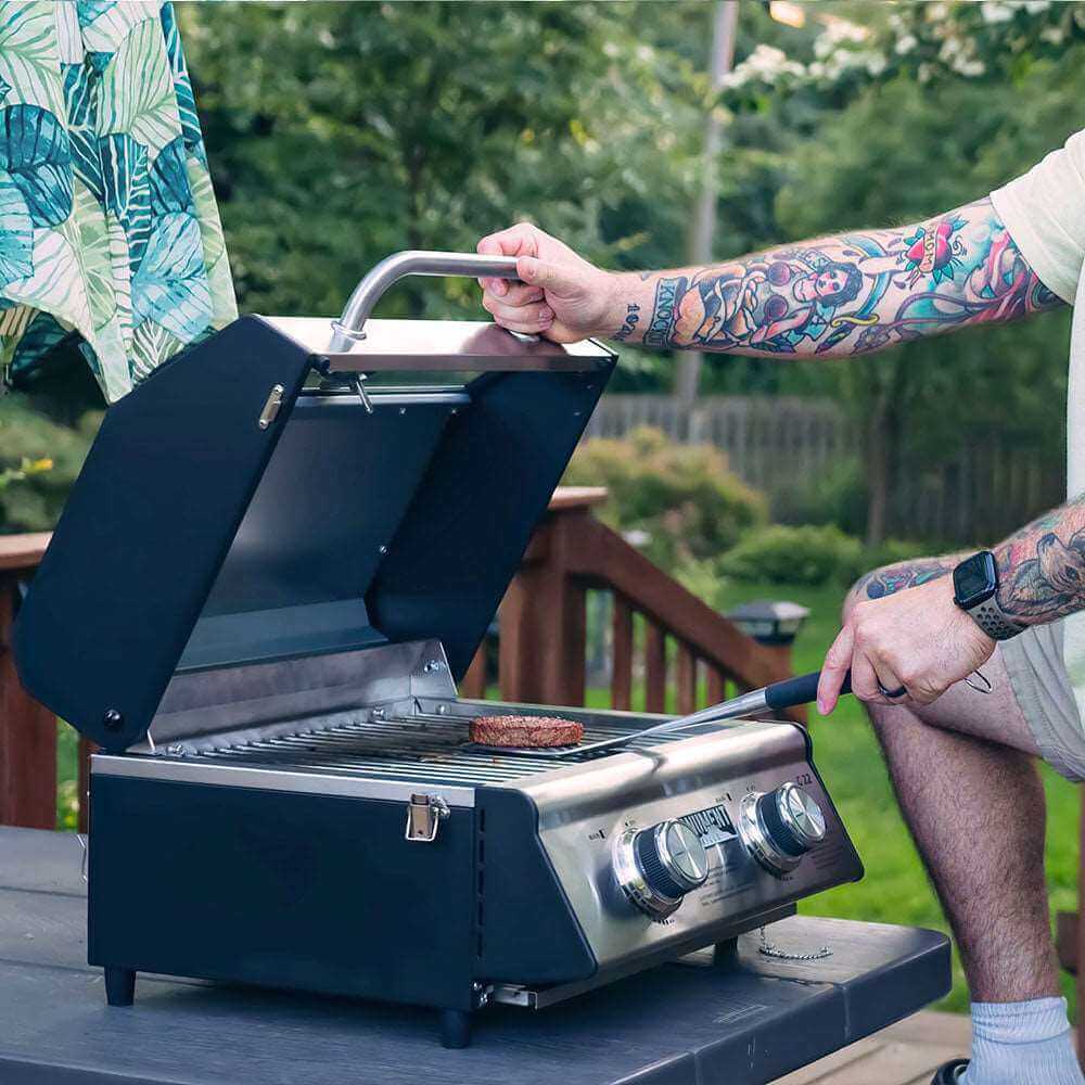 Stainless G22 tabletop propane gas grill by Monument Grills with stainless steel construction and compact design for outdoor cooking.