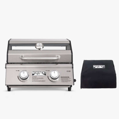 Stainless G22 Monument Grills tabletop propane gas grill with lid, side handle, and control knobs for outdoor cooking.