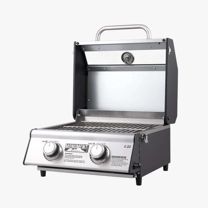 Stainless G22 Monument Grills tabletop propane gas grill with lid and control knobs, ideal for outdoor cooking.