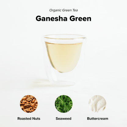 Organic Ganesha Green Tea by Nepal Tea, fresh green tea leaves in a clear cup, highlighting vibrant green color and natural aroma.