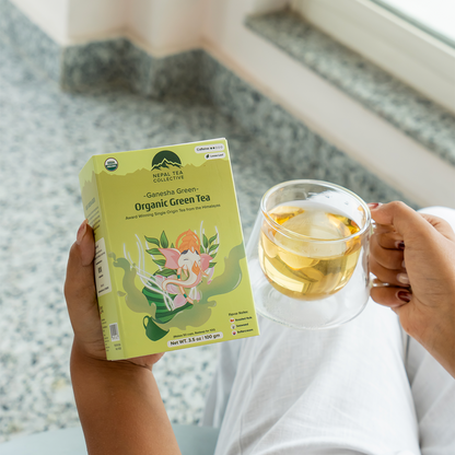Organic Ganesha Green Tea by Nepal Tea, fresh green tea leaves with Ganesha artwork packaging, ideal for healthy brewing.