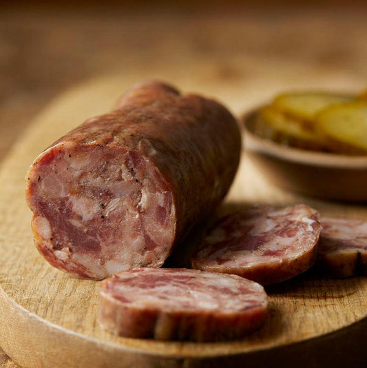 Sliced bourbon and bacon meat product from Gastros Craft Meats, showcasing marbled bacon infused with bourbon flavor.