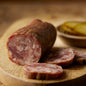 Sliced bourbon and bacon meat product from Gastros Craft Meats, showcasing marbled bacon infused with bourbon flavor.