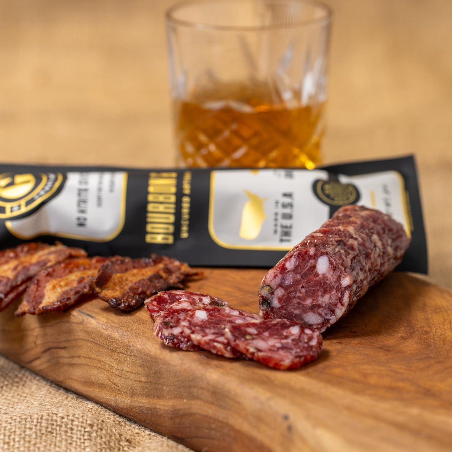 Slices of Bourbon & Bacon from Gastros Craft Meats, showcasing smoky bacon with a bourbon glaze on a white plate.