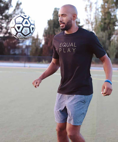 Black Equal Play men's athletic T-shirt by Goal Five, designed for active lifestyle, shown on a model.