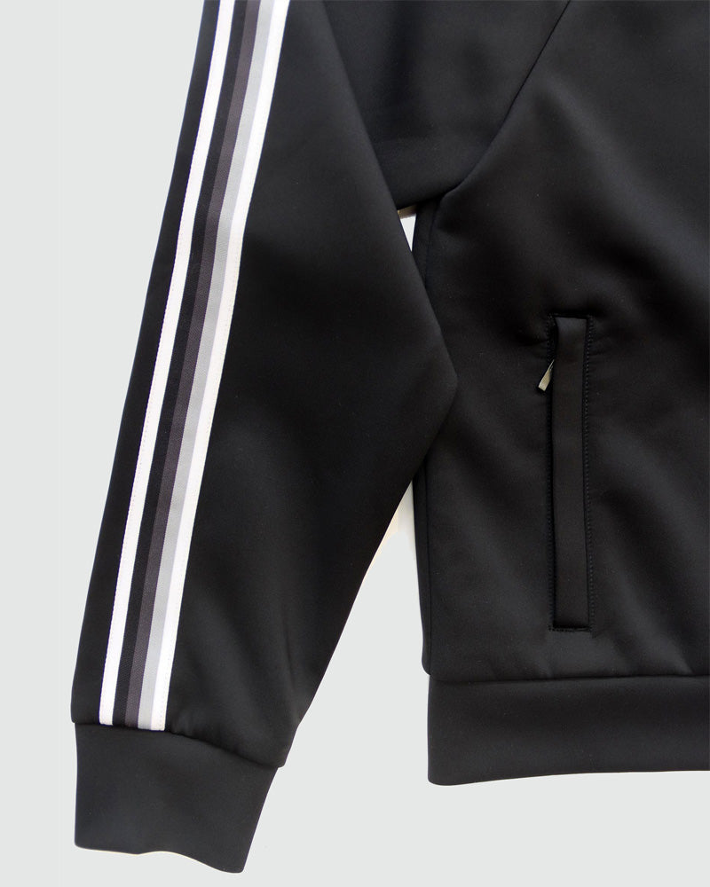 Black Goal Five Powerstripe LS Track Jacket, lifestyle image showing lightweight athletic jacket with stripe details on sleeves.