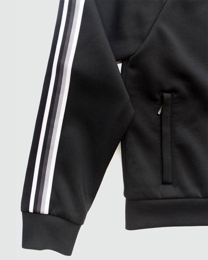 Black Goal Five Powerstripe LS Track Jacket, lifestyle image showing lightweight athletic jacket with stripe details on sleeves.