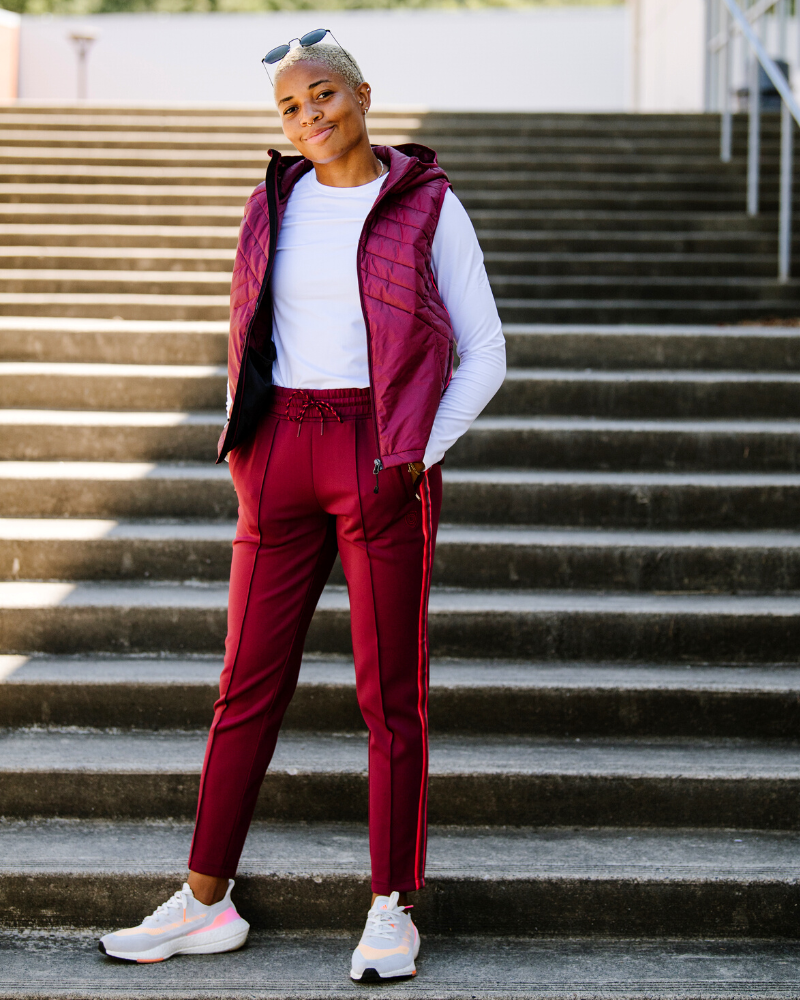 Black Goal Five Powerstripe mid-rise 28-inch 7/8 length track pant for lifestyle wear, featuring sporty style and comfortable fit.