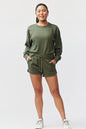 Goal Five Freasy Short in dark moss color, lifestyle image showing lightweight, comfortable fitness shorts for men.