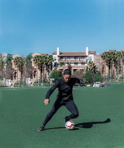 Black women's soccer training tights by Goal Five with built-in shin guard pocket, designed for comfort and performance.