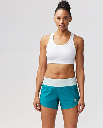 Black Excel Women's Workout Shorts from Goal Five, designed for training, shown on a woman with a close-up view of the shorts.
