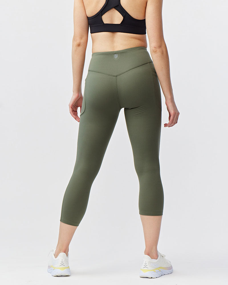 Black Goal Five Go Again women's cropped training leggings, 21-inch length, close-up view of stretchy fabric and fit