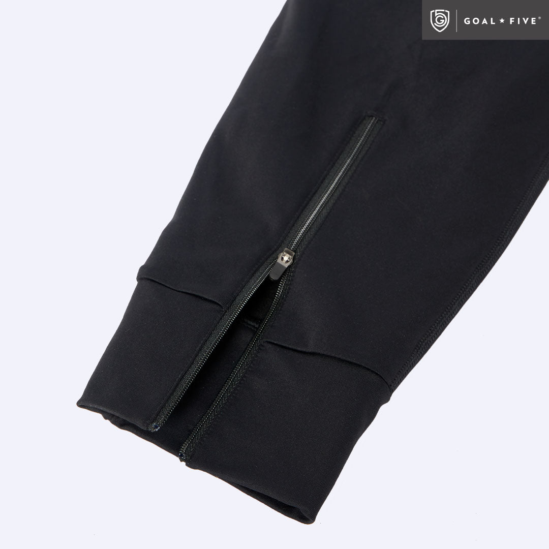 Black Valia women's training jogger pants by Goal Five, shown fitted on a model, with a relaxed athletic style and elastic waistband.