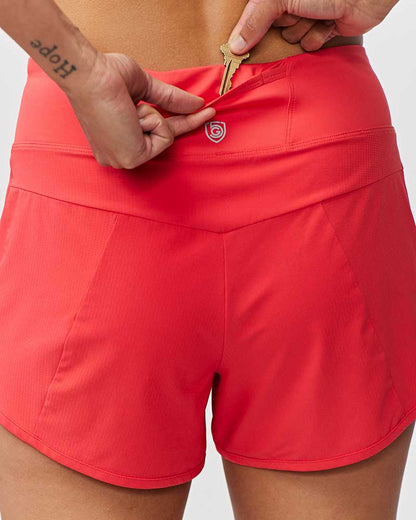 Goal Five Sheva women's high-rise training running shorts in hot coral, showing the waistband and lightweight fabric for active wear.