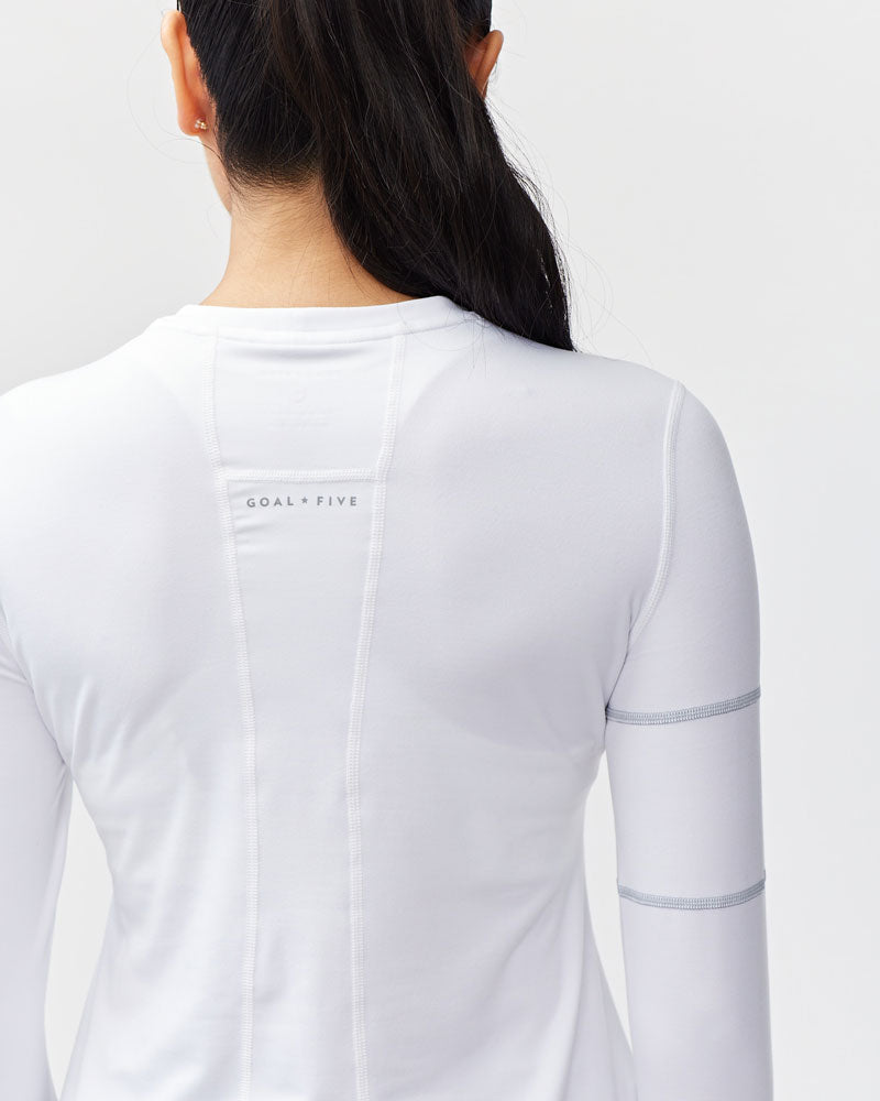 White Foudy women's long-sleeve workout top by Goal Five, designed for training and active wear.