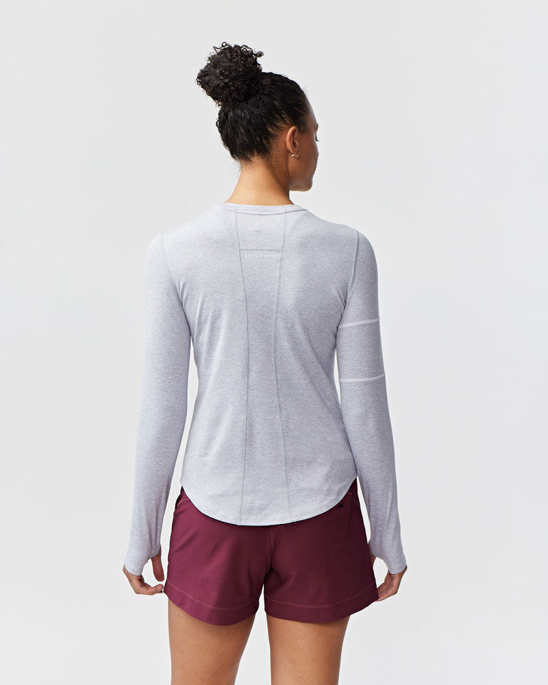 White Foudy women's long sleeve workout top by Goal Five, designed for training and active wear, shown on a model.