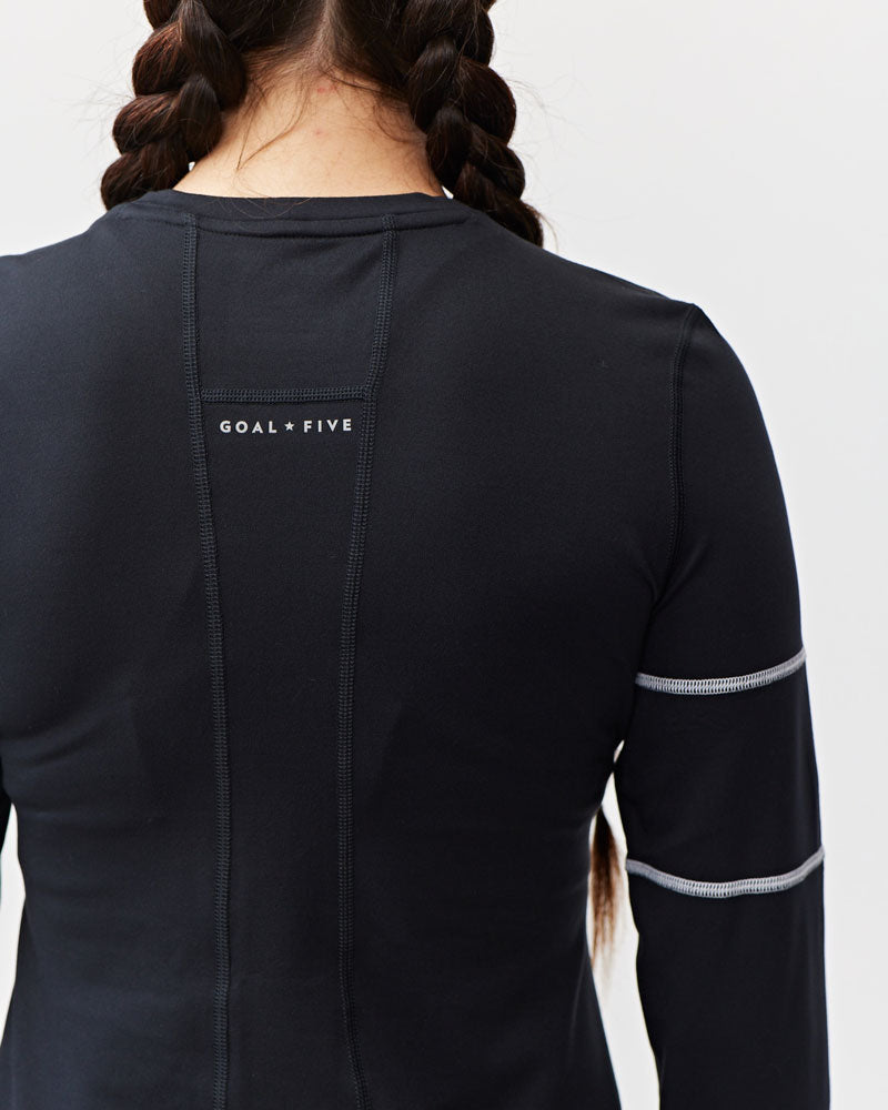 White Foudy women's long sleeve workout top by Goal Five, designed for training and active wear.