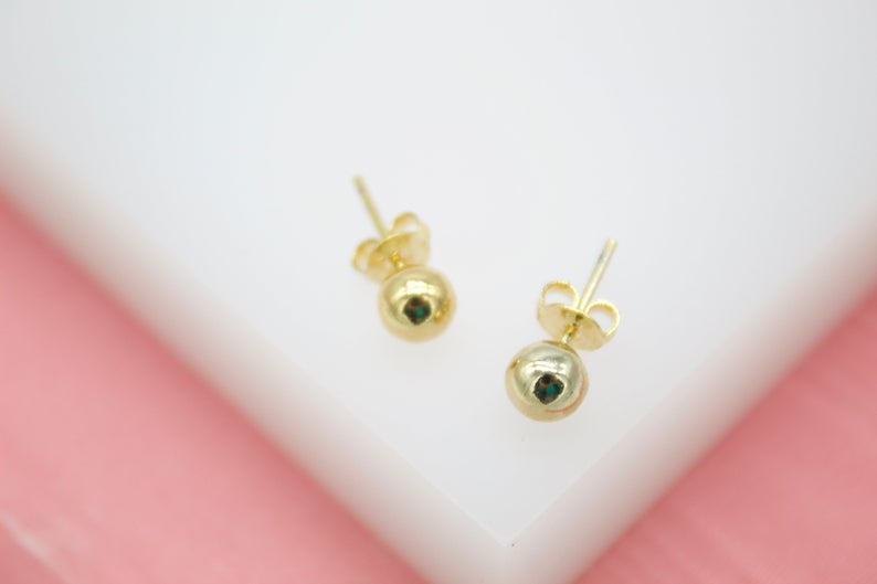 Small 18K gold-filled ball stud earrings by MIA Jewelry, featuring tiny, minimalist design perfect for everyday wear.
