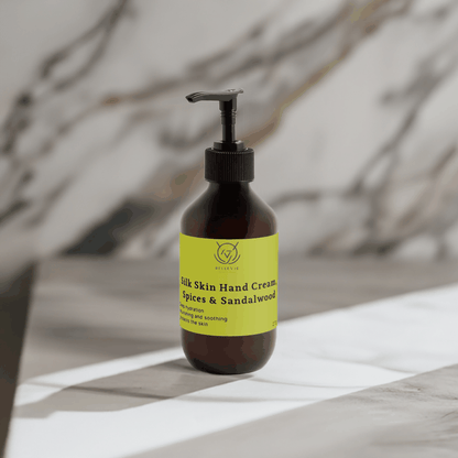 BelleVie Cosmétiques Silk Skin Hand Cream with spices and sandalwood, showing a creamy hand cream texture in a 270ml container.