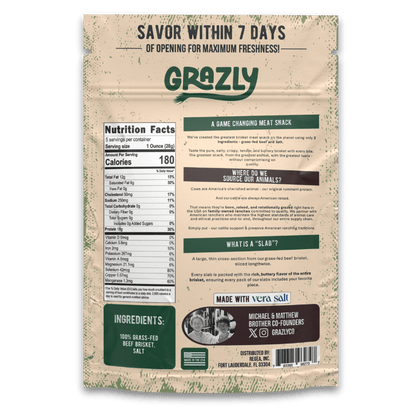 A pack of Grazly beef brisket slabs, 100% grass-fed and finished, showing fresh raw meat with marbling and packaging labels.