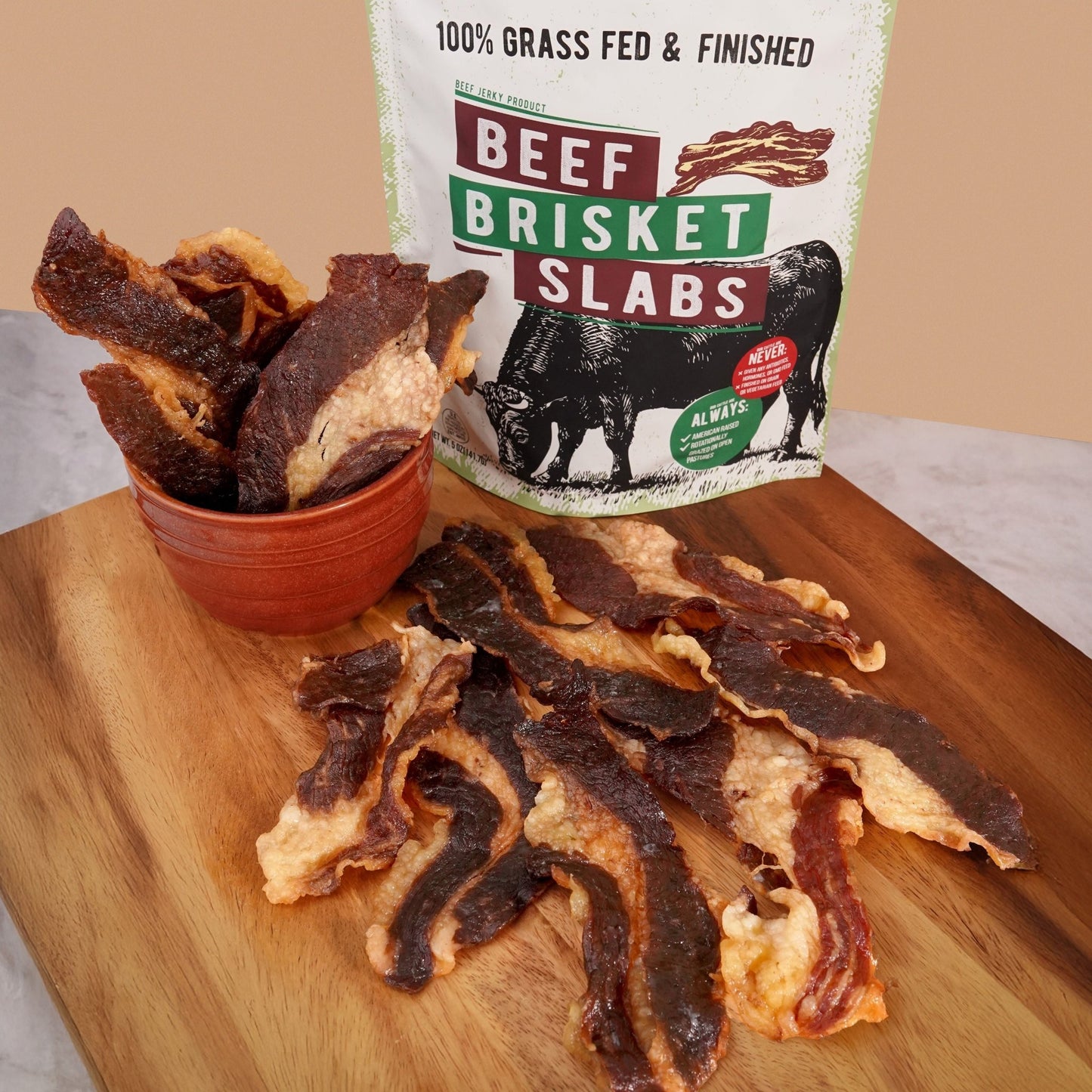 Pack of Grazly 100% grass-fed beef brisket slabs, showcasing fresh, raw meat with marbling and natural red color.
