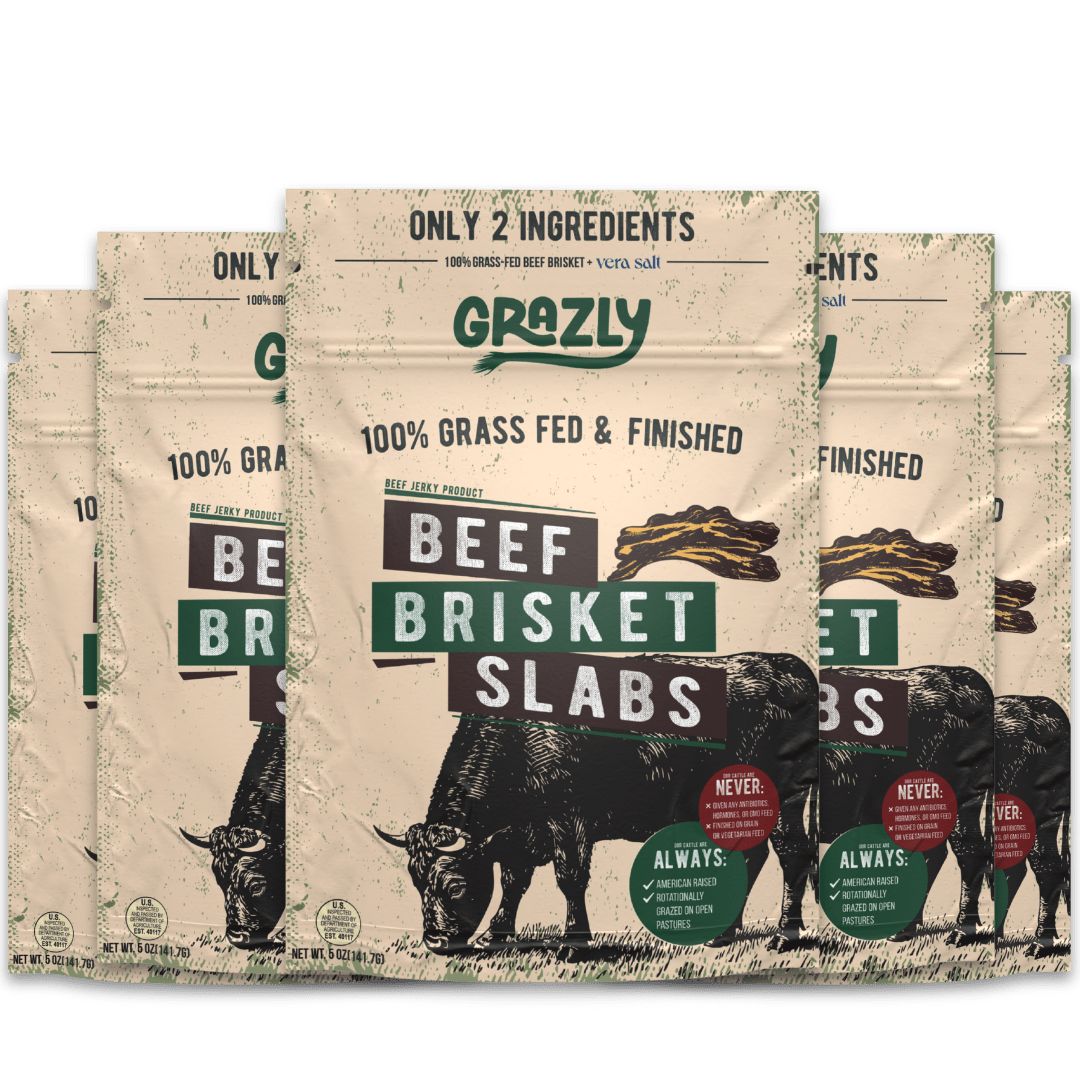 Beef brisket slabs from Grazly, 100% grass-fed and finished, raw meat with marbling on a cutting board.