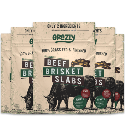 Beef brisket slabs from Grazly, 100% grass-fed and finished, raw meat with marbling on a cutting board.