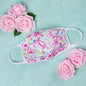 Vibrant cloth face mask with Americana design by GreaterGood, made in the USA, showing colorful fabric and mask straps.