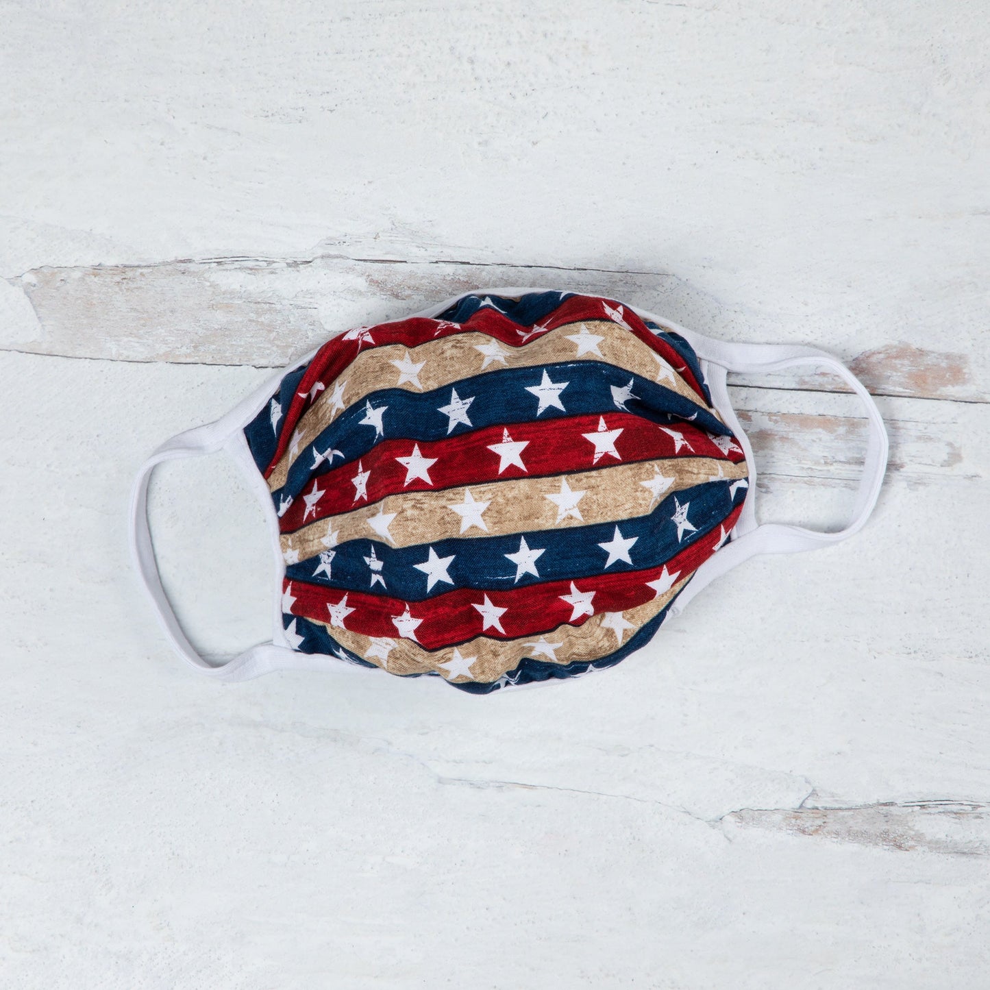 Vibrant cloth face mask with Americana design by GreaterGood, made in the USA, featuring colorful patterns and comfortable fit.