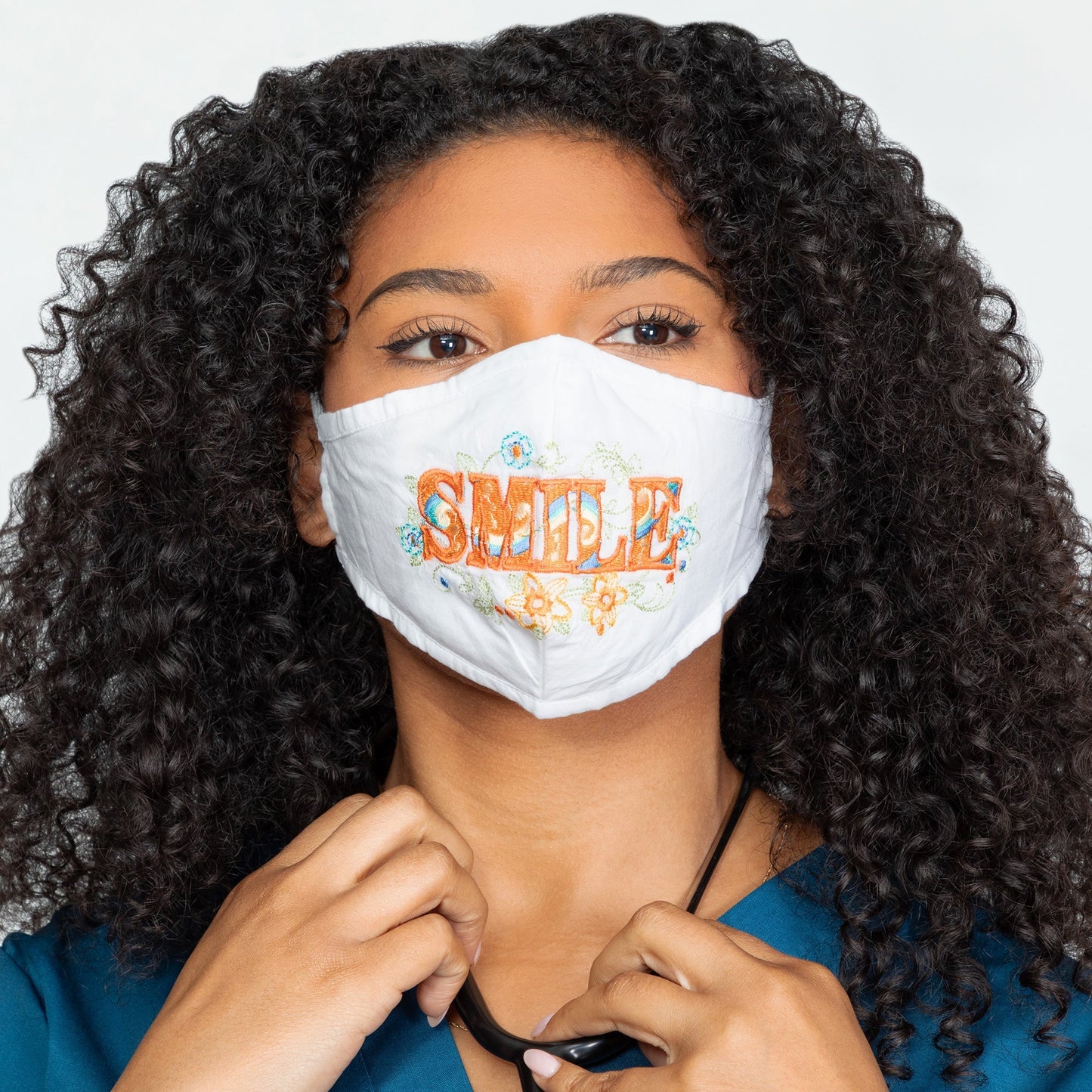 GreaterGood Read My Lips embroidered face mask with "Be Kind" message, made of soft fabric, featuring colorful embroidery design.