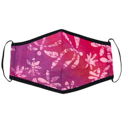 Batik Delight face mask by GreaterGood featuring a colorful dragonfly and floral pattern on soft fabric.
