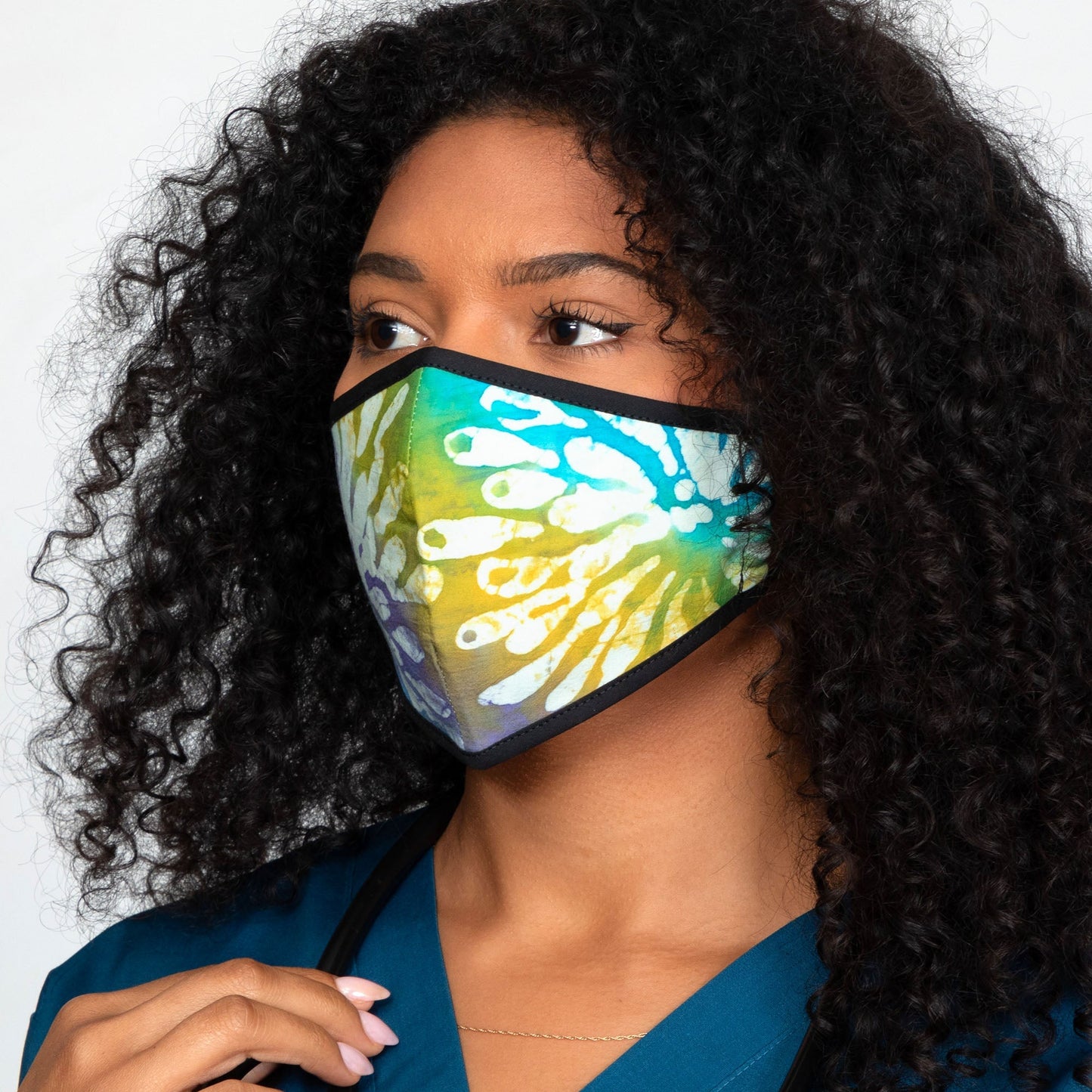 Batik Delight face mask by GreaterGood featuring vibrant dragonfly and floral batik patterns for stylish protection.