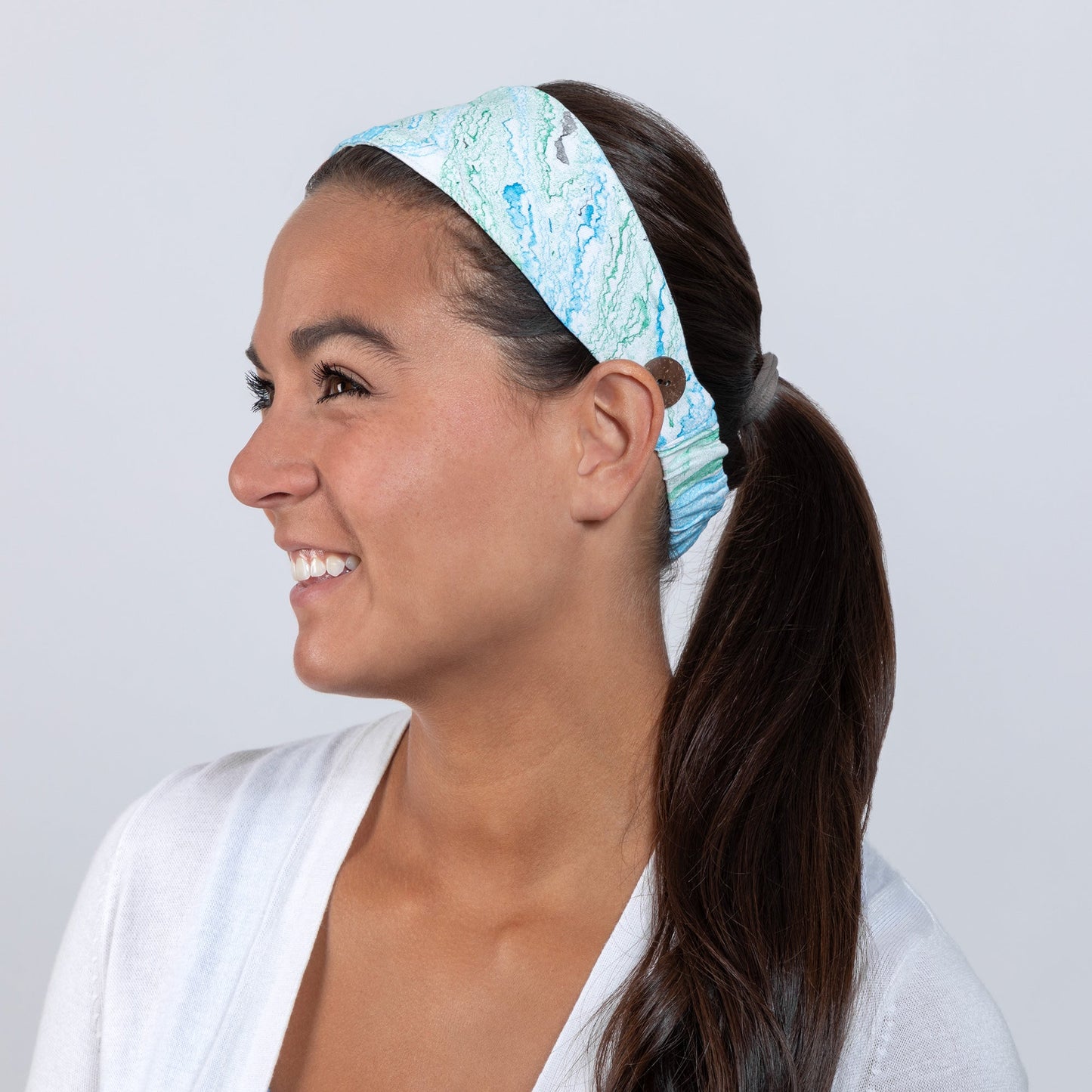Green and blue Marbleous color face mask with matching headband from GreaterGood, made of comfortable fabric for face covering and accessories.