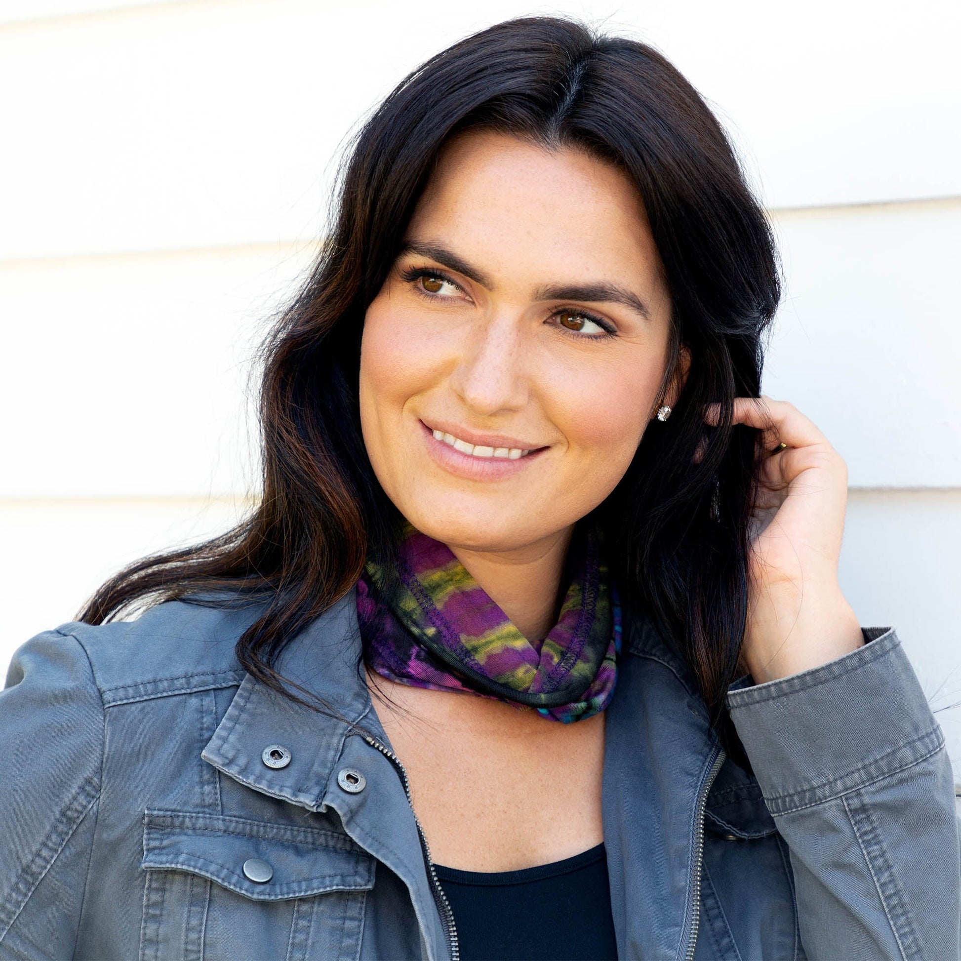 Colorful tie-dye gaiter face mask by GreaterGood, made of soft fabric, designed for versatile face covering and protection.