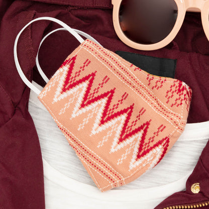 Handwoven GreaterGood face mask with intricate patterns, made of soft fabric, designed for comfort and style.