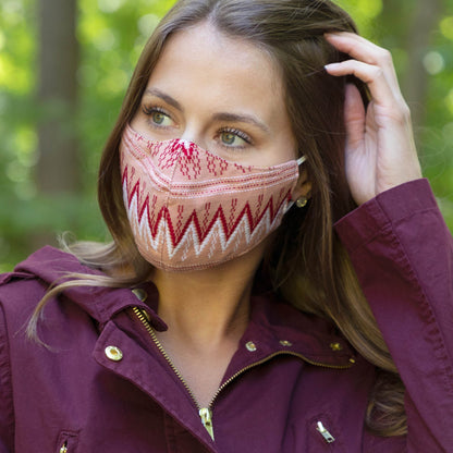 Handwoven GreaterGood face mask with colorful patterns, made of breathable fabric for comfortable wear and face protection.