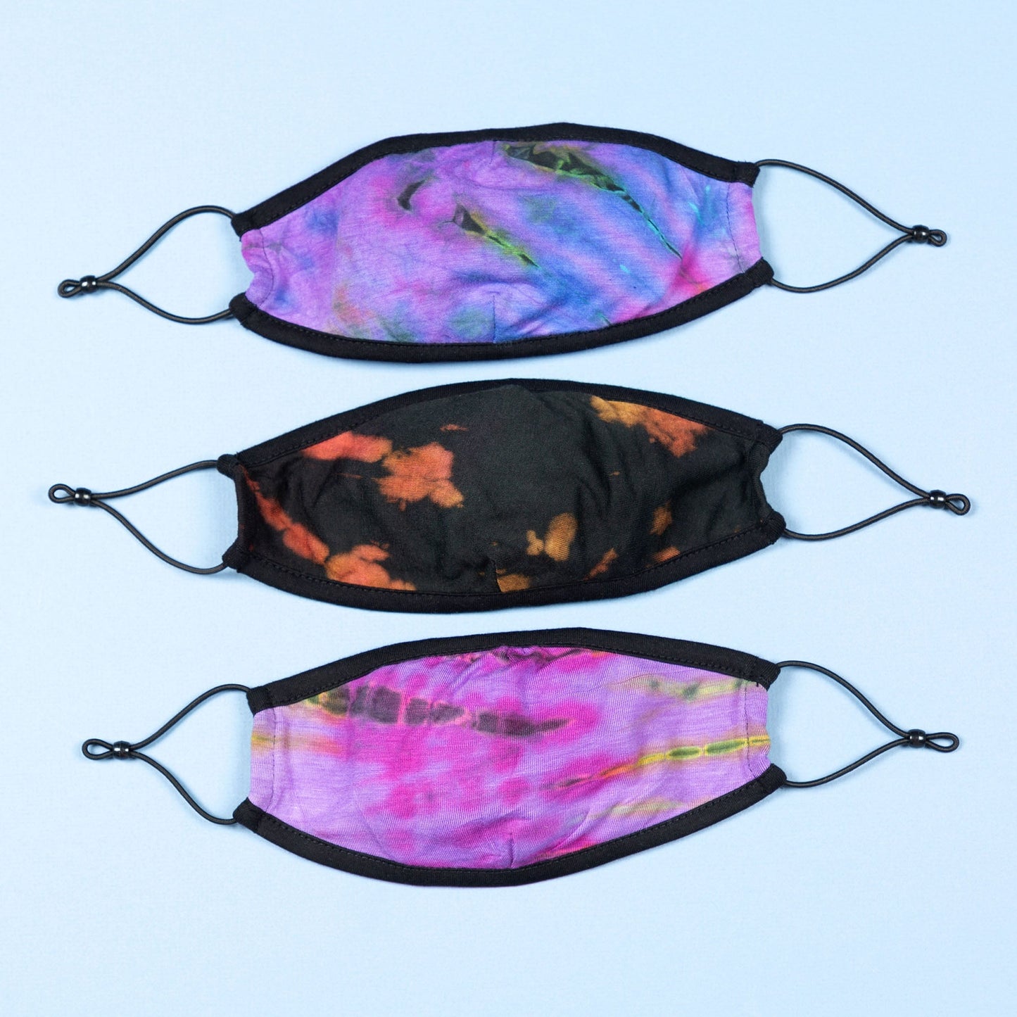 Set of three tie-dye face masks by GreaterGood, protective face masks with colorful patterns, and mask accessories.
