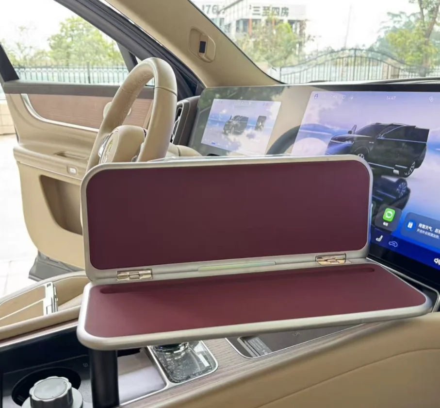 Starlink 180° rotatable folding car desk with steering wheel tray, laptop and writing surface for vehicle interior use.