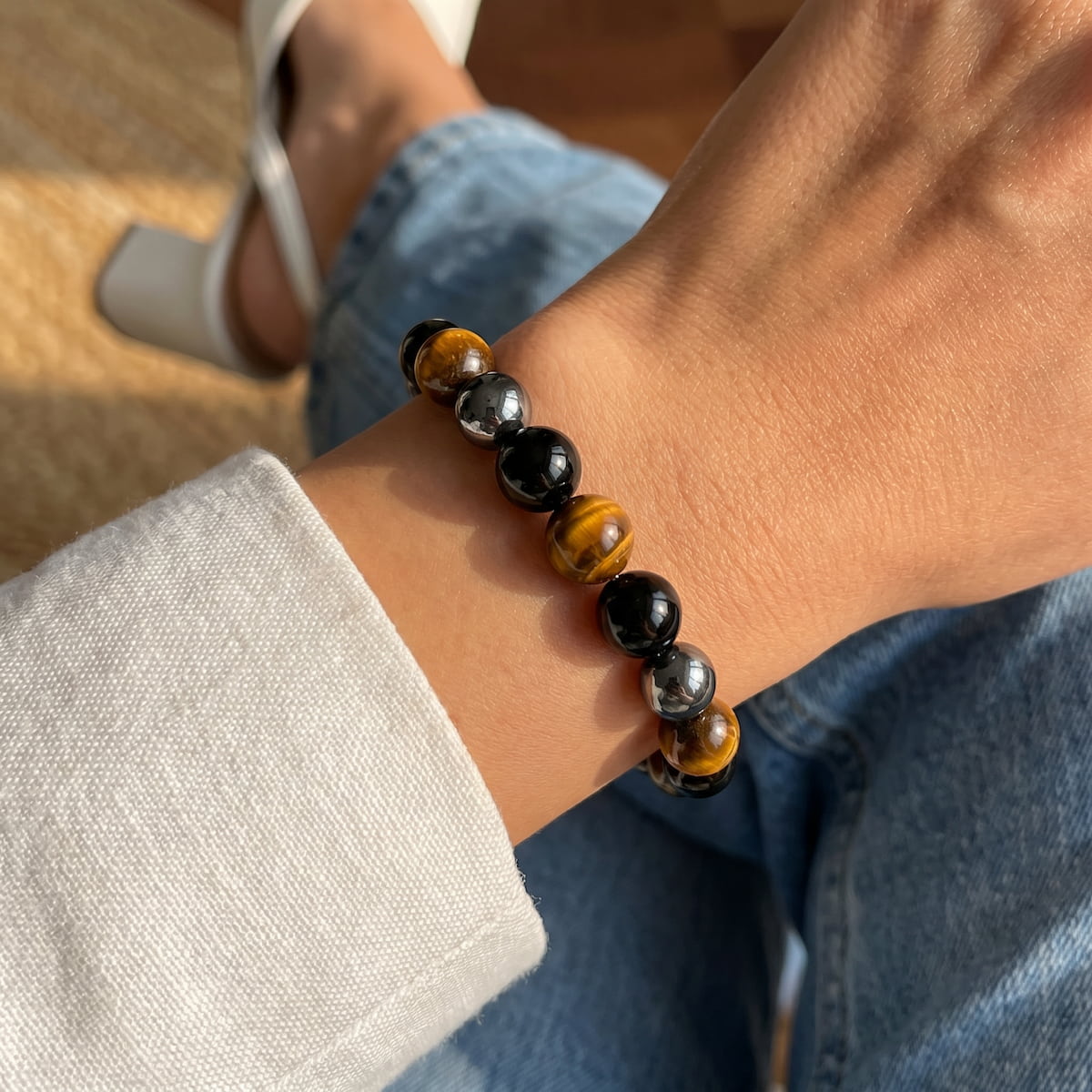 Conscious Items Triple Protection Bracelet featuring layered black and silver beads on a durable cord.