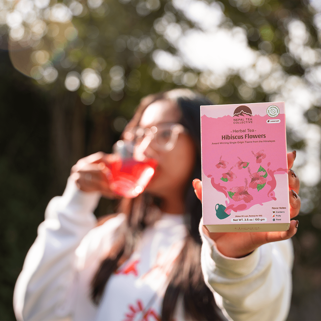 Organic Nepal Tea hibiscus blend in a glass jar, showcasing vibrant dried hibiscus flowers for herbal tea.