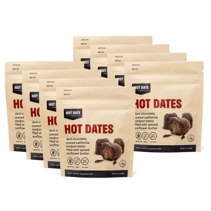 Eight packs of Hot Date Kitchen spiced dark chocolate stuffed Medjool dates, candied fruit with chocolate coating in pouches.