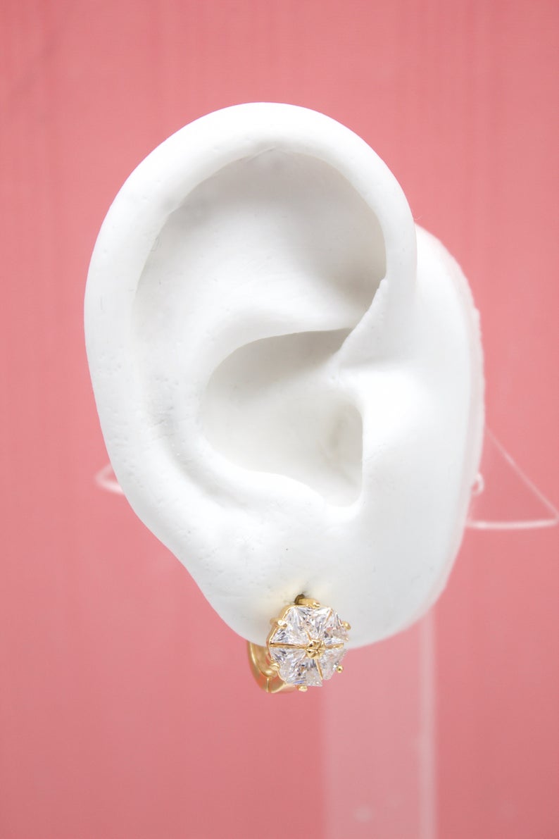 MIA Jewelry Flower CZ Gemstone Huggies Earrings with floral design and sparkling gemstones, silver-tone metal.