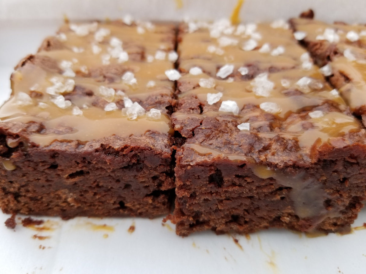 Salted caramel brownies from Let's Get Baked Artisan Desserts, showing rich, chocolatey cakes with caramel drizzle and a salted topping.