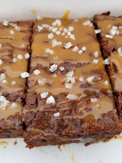 Salted caramel brownies from Let's Get Baked Artisan Desserts, showcasing rich chocolate and salted caramel topping on a dessert bar.