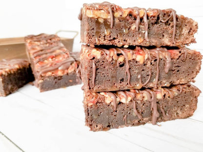 Chocolate turtle brownies from Let's Get Baked Artisan Desserts, featuring rich chocolate, caramel, and pecans in a decadent cake bar.