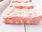 Strawberry Blondies from Let's Get Baked Artisan Desserts, featuring golden cake bars with visible strawberry pieces and a glossy finish