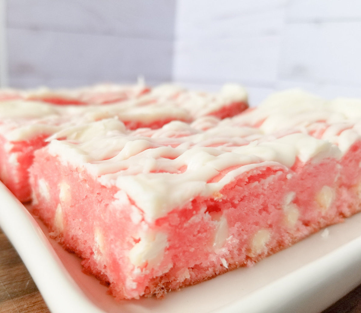 Strawberry blondies from Let's Get Baked Artisan Desserts, featuring a golden cake bar with fresh strawberry bits.
