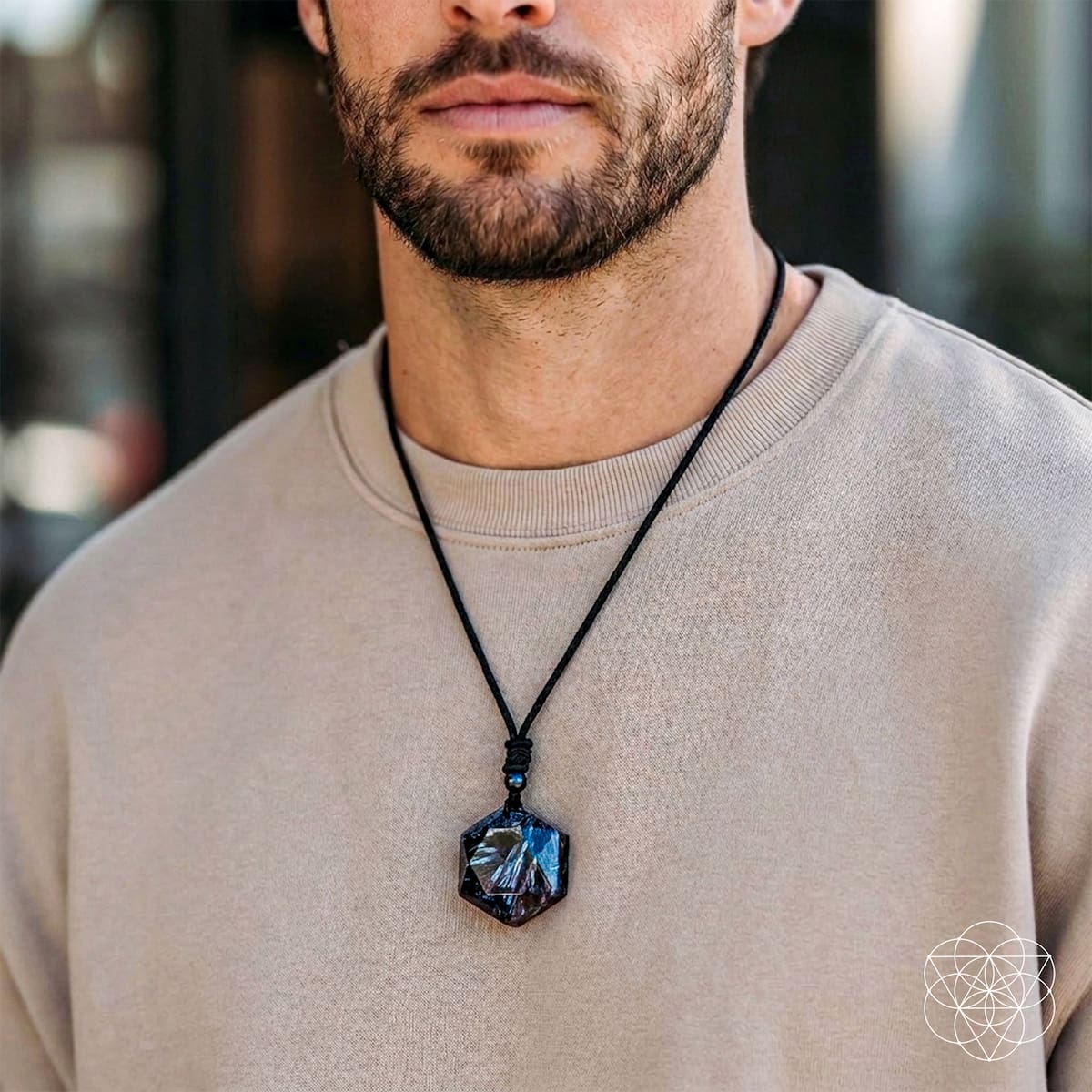 Deep healing Arfvedsonite pendant necklace by Conscious Items featuring a polished, dark mineral pendant on a cord.