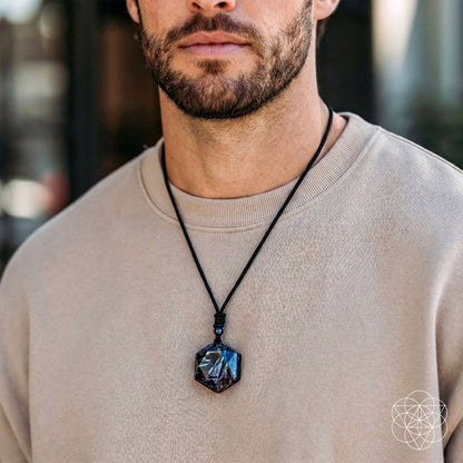 Deep healing Arfvedsonite pendant necklace by Conscious Items featuring a polished, dark mineral pendant on a cord.