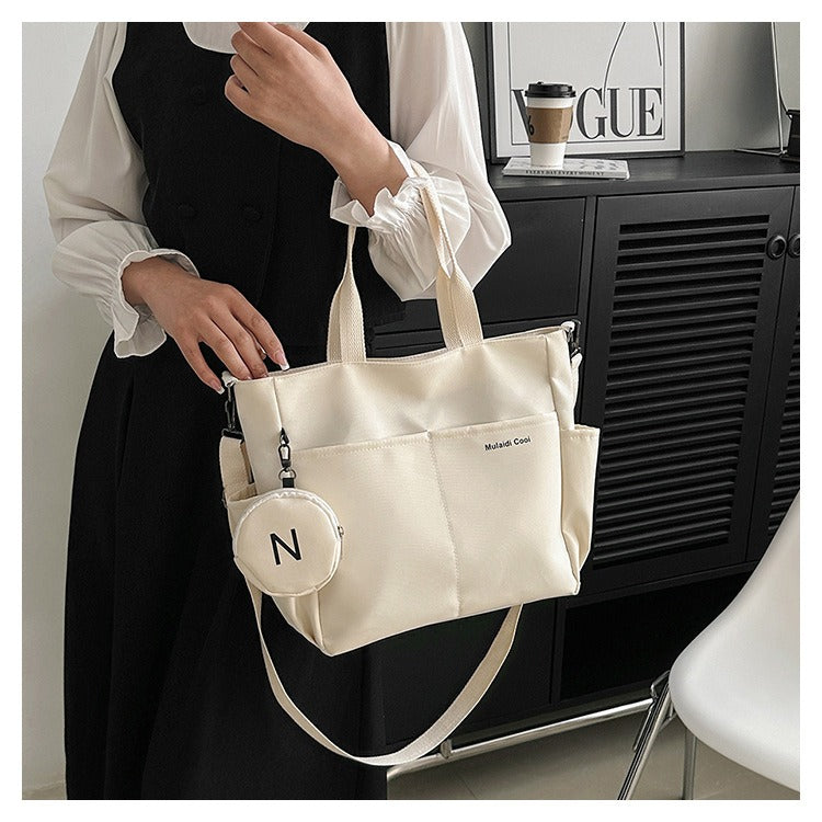 Beige women's Oxford tote crossbody shoulder handbag by LPO with adjustable strap and spacious interior for everyday use.